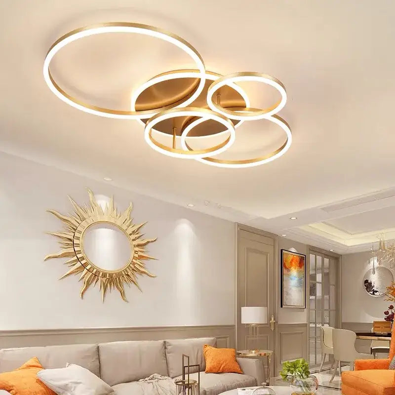 Modern gold-toned decorbites™ led rings ceiling chandelier with overlapping circular rings for dimmable living room lighting