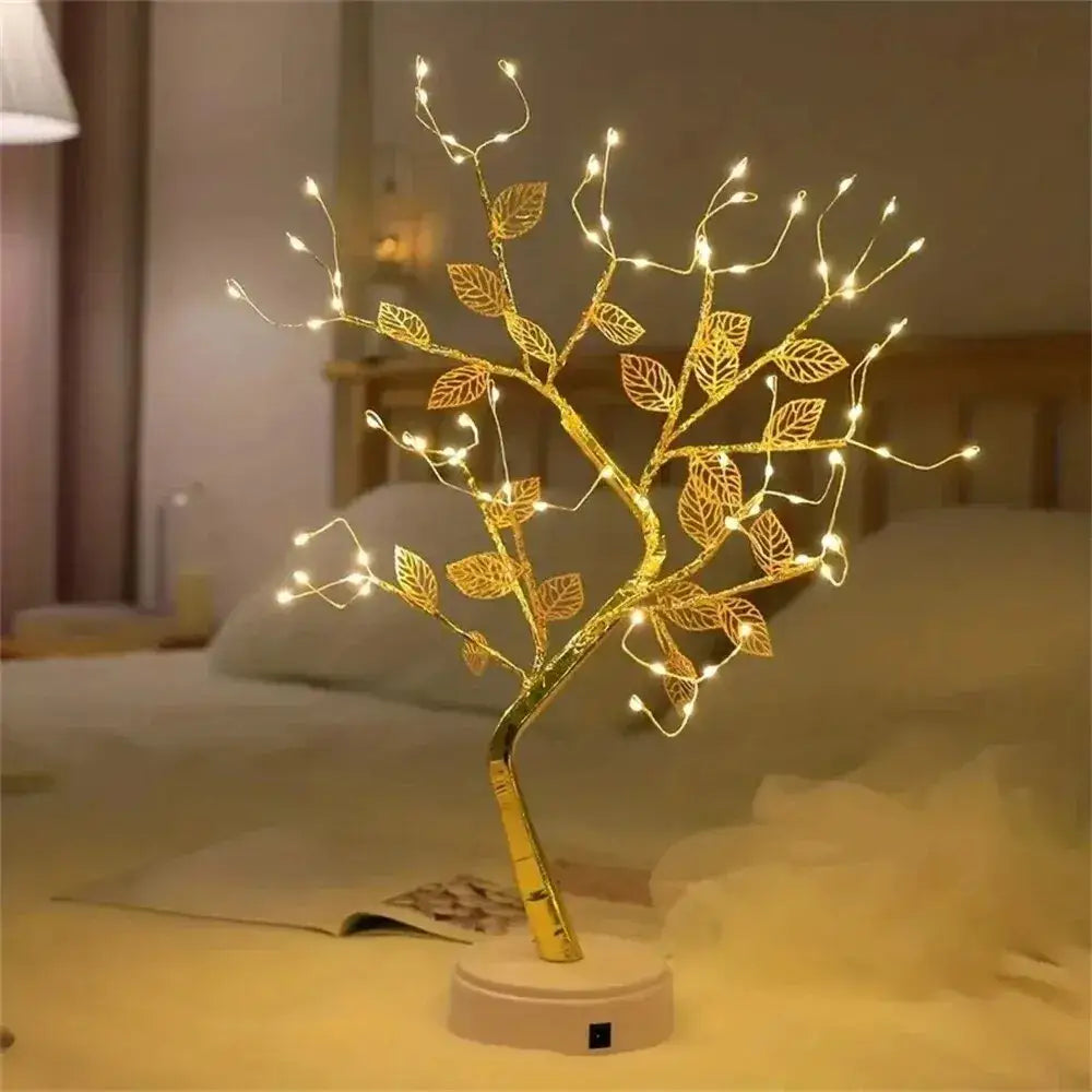 Golden wire tree fairy lamp with illuminated leaves and branches in sleek metallic finish ideal for christmas tree decor