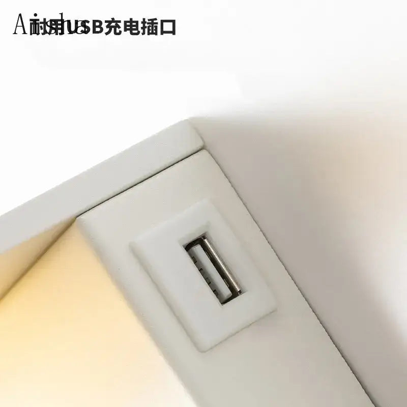 White plastic usb charging port with metallic contacts on the back of decorbites™ led rotary square wall lamp