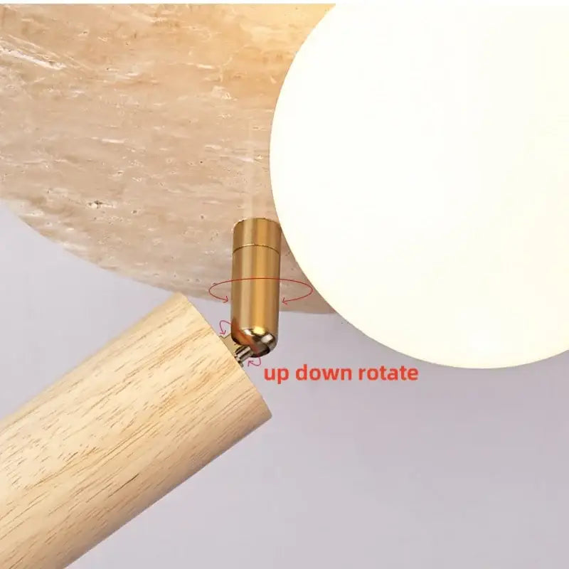 Gold-toned adjustable joint connecting wooden arm to frosted glass shade of decorbites led rotatable ceiling lamp