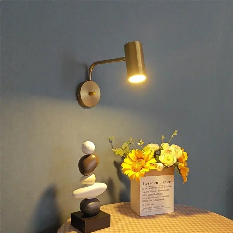 Brass wall lamp with cylindrical head and curved arm from DecorBites™ led rotatable wall lamps in black gold white sconce