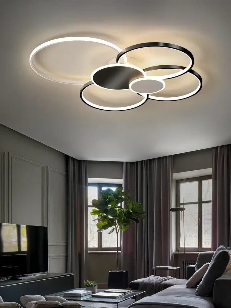 Modern black and white led round ceiling chandelier with overlapping rings for living room decor by DecorBites™