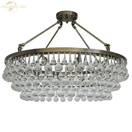 Brass-finished DecorBites led round glass chandelier with teardrop crystal pendant lights for modern living spaces