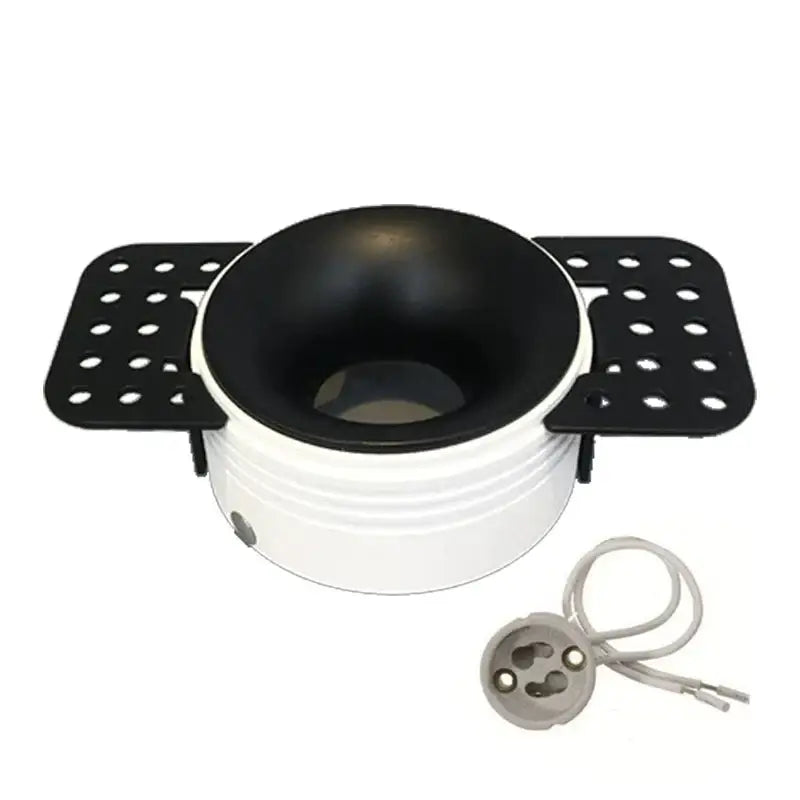 White and black ceramic bowl with perforated side trays complementing decorbites led round recessed ceiling fixture