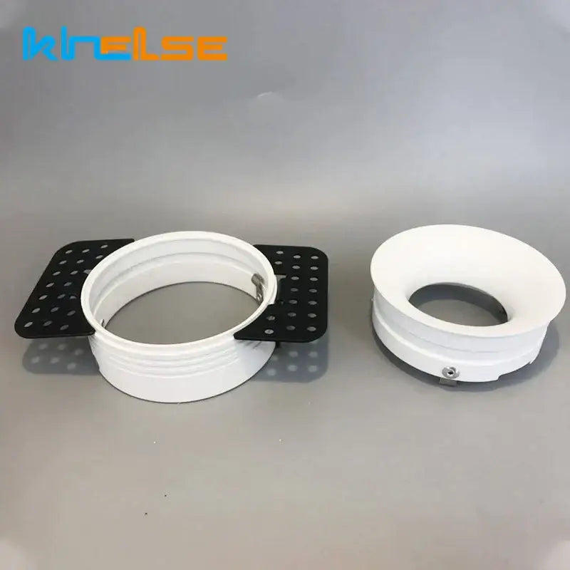 White plastic pipe adapter with black perforated mounting plate on back side of decorbites led round recessed ceiling lamp holder