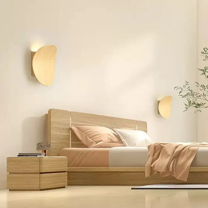 Pair of DecorBites™ LED round wall lamps with minimalist crescent shape and warm-toned wood finish for indoor lighting