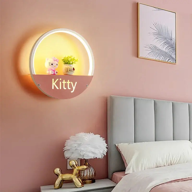Decorbites led round wall lamp for children room with warm pink and white circular design and gold kitty lettering