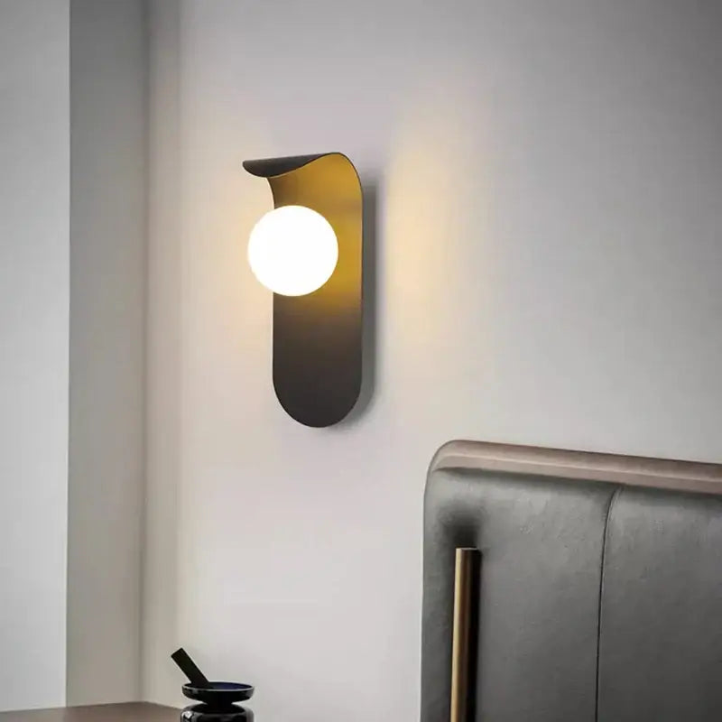 Modern decorbites led round wall lamp with a sleek curved metallic body and warm led round bulb for living room lighting