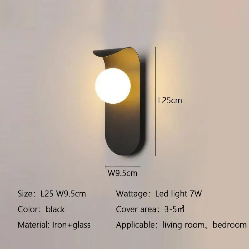 Black iron and glass DecorBites LED round wall lamp with sleek curved body and round illuminated bulb for modern rooms