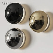 Three spherical reflective mirrors in black gold and silver finishes complement the decorbites led scandinavian sconce wall lamp