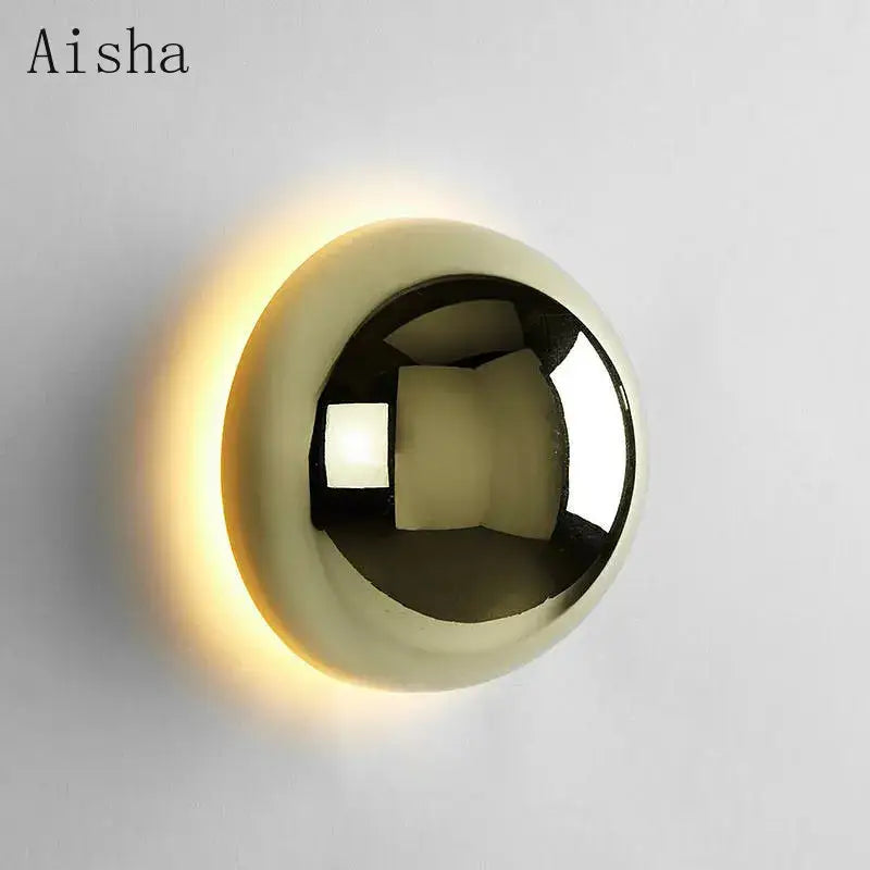 A sleek spherical wall lamp with polished gold finish and warm glow decorbites led scandinavian sconce for modern decor