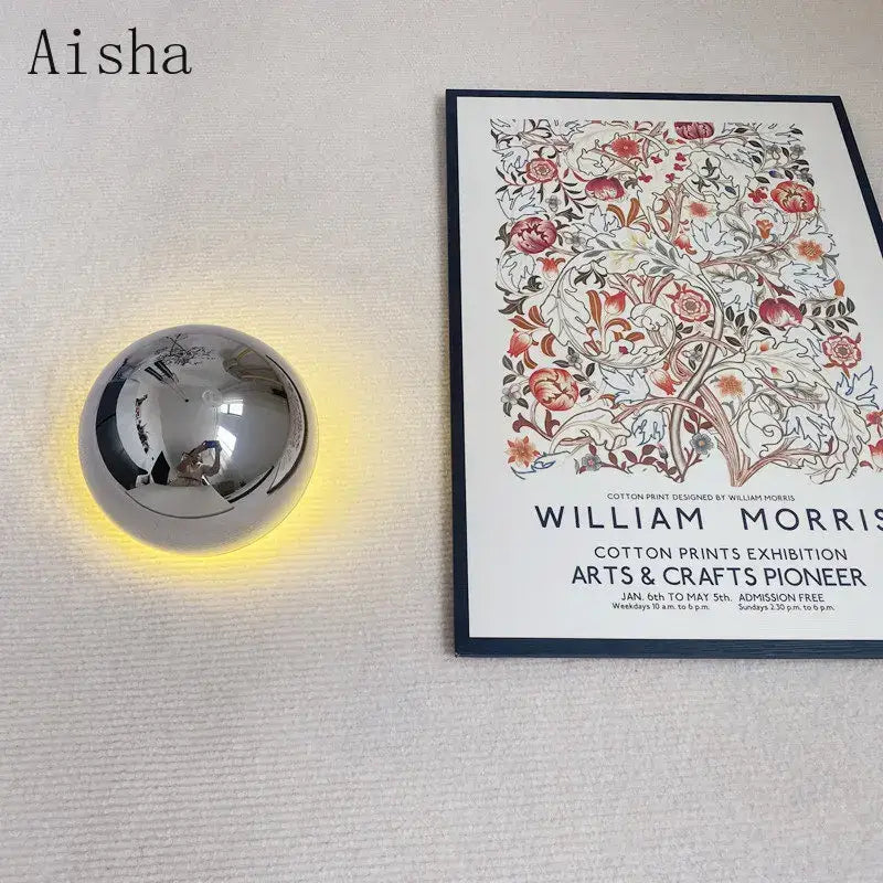 Shiny chrome spherical decorbites led Scandinavian sconce wall lamp emitting warm yellow glow for modern medieval decor