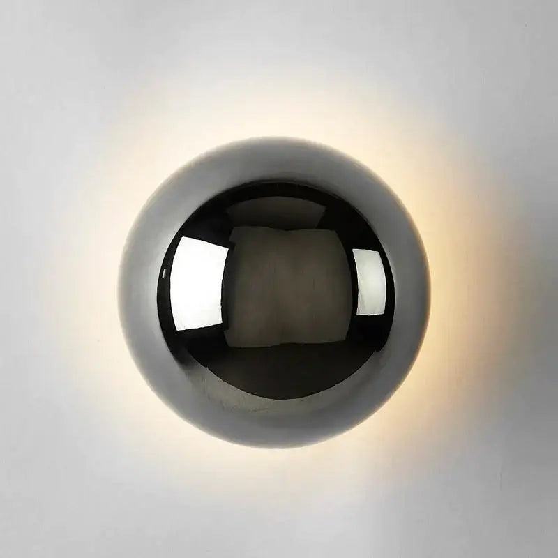 A sleek spherical wall lamp with polished chrome finish and warm glow decorbites led scandinavian sconce for modern decor