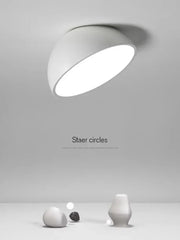 A sleek modern white decorbites led semicircular ceiling light with a smooth curved dome design for bedroom use