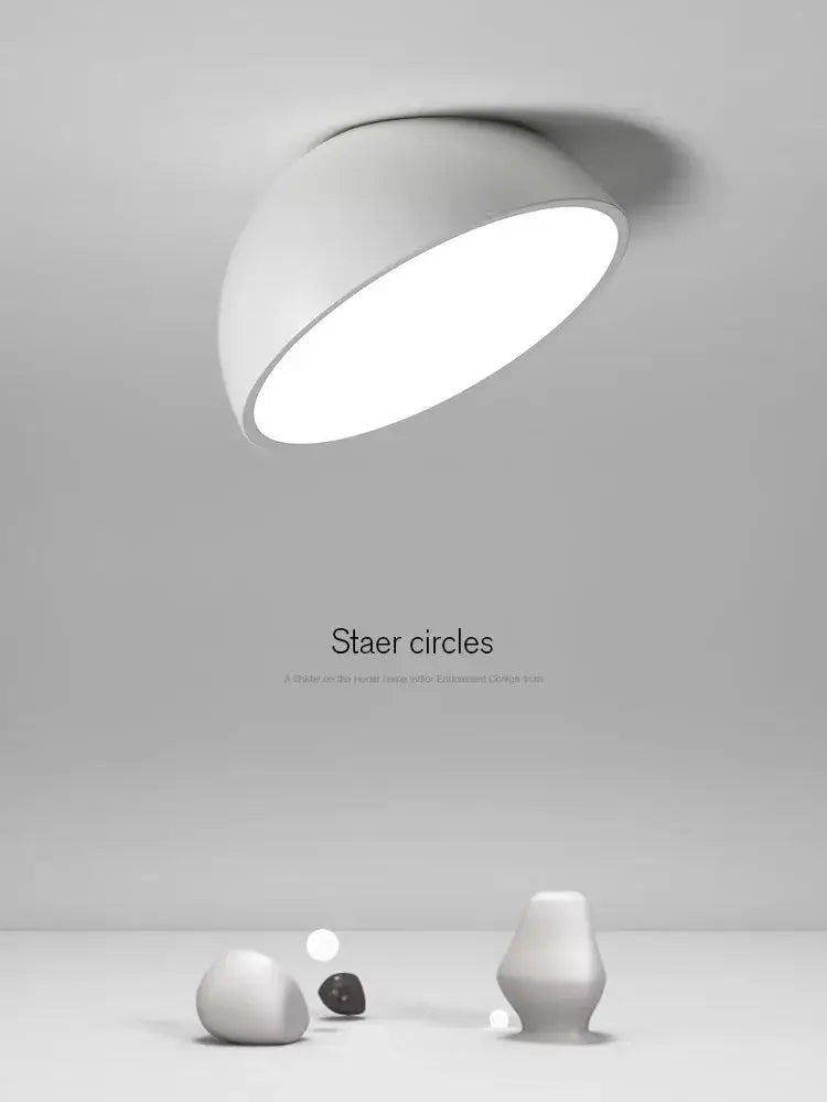 A sleek modern white decorbites led semicircular ceiling light with a smooth curved dome design for bedroom use