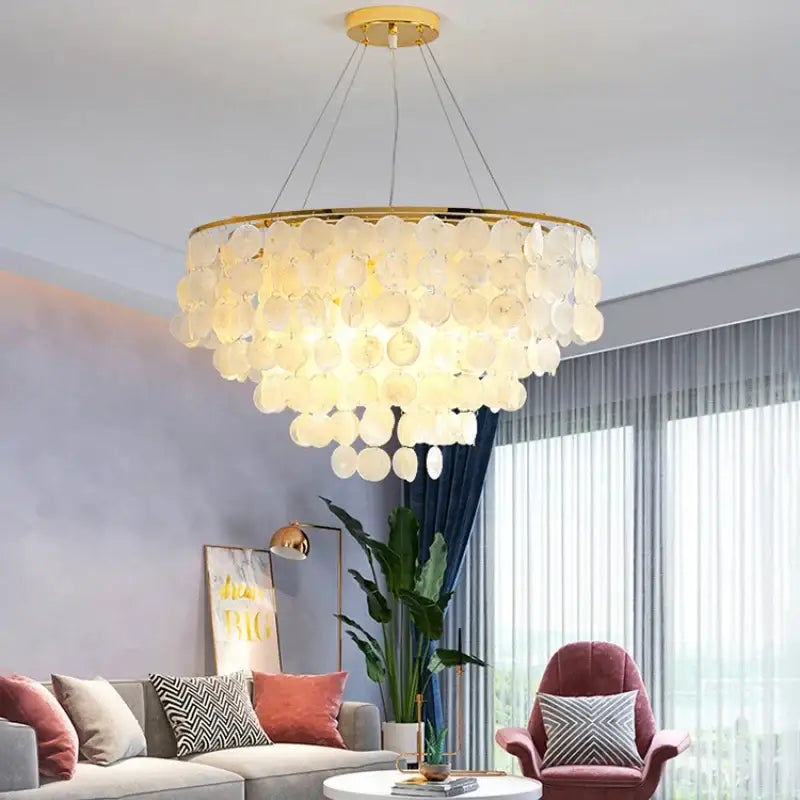 DecorBites led shell chandelier with cascading translucent white shell discs on polished gold chrome frame
