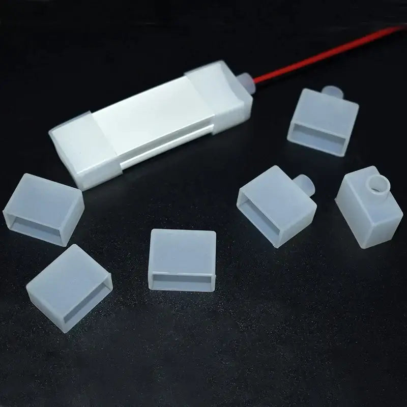 White plastic rectangular cable cover with tabs for DecorBites™ silicone tube led strip light end cap kit