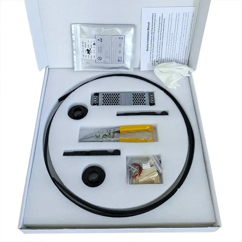 Black flexible cable with metallic connector and yellow-handled tool inside white box for decorbites led skyline ceiling wall lamp