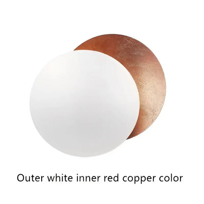 White and copper-colored circular cake boards complement decorbites led solar eclipse wall lamp for modern indoor lighting