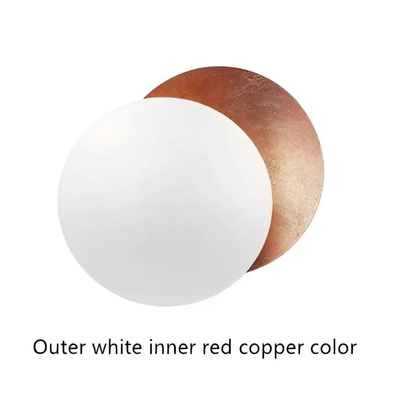 White and copper-colored circular cake boards complement decorbites led solar eclipse wall lamp for modern indoor lighting