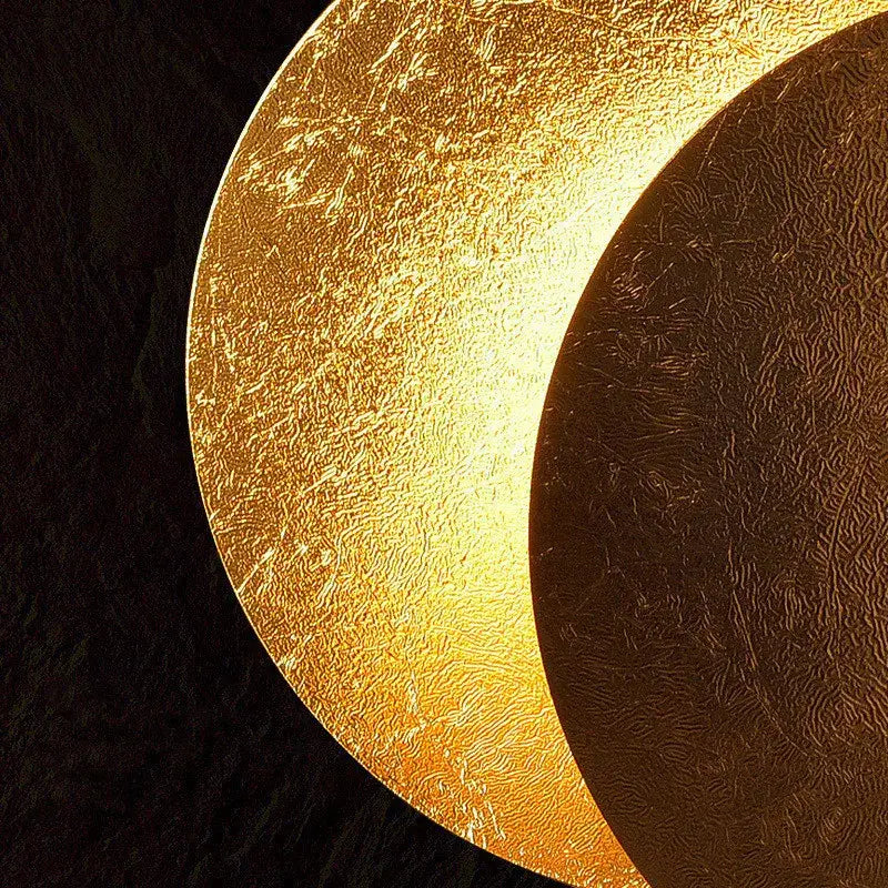 A textured golden crescent-shaped decorbites led solar eclipse wall lamp with a warm glowing finish for indoor lighting