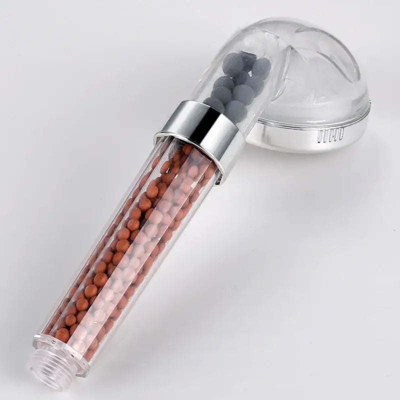 Clear plastic decorbites led spa shower head with chrome metal band and brownish-orange and gray beads inside body