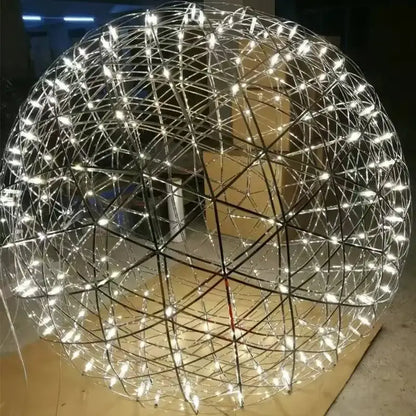 A spherical decorbites led spark pendant light with stainless steel geometric lattice and white led spark ball illumination