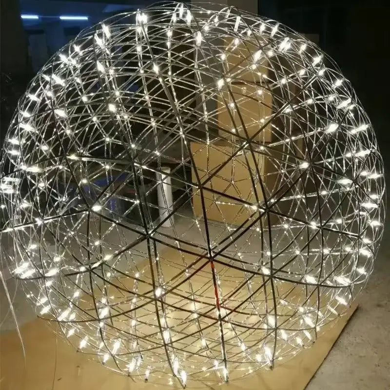A spherical decorbites led spark pendant light with stainless steel geometric lattice and white led spark ball illumination