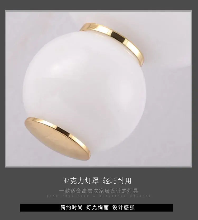 A sleek white acrylic decorbites led spiral ball pendant with polished gold metal rims for modern interior lighting