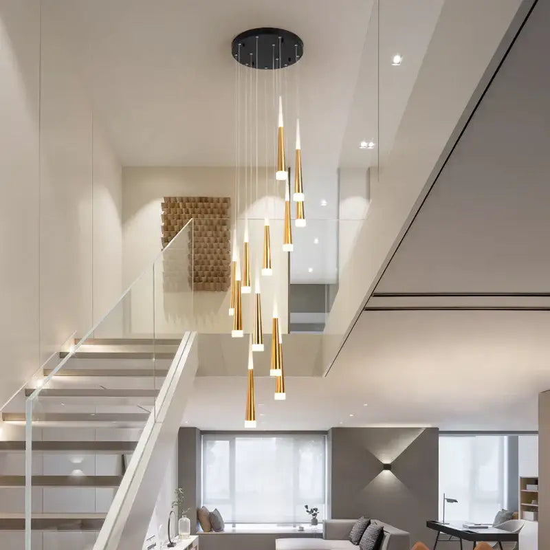 Modern gold-toned DecorBites LED spiral chandelier with tapered cylindrical shades on black ceiling mount for stairwell lighting