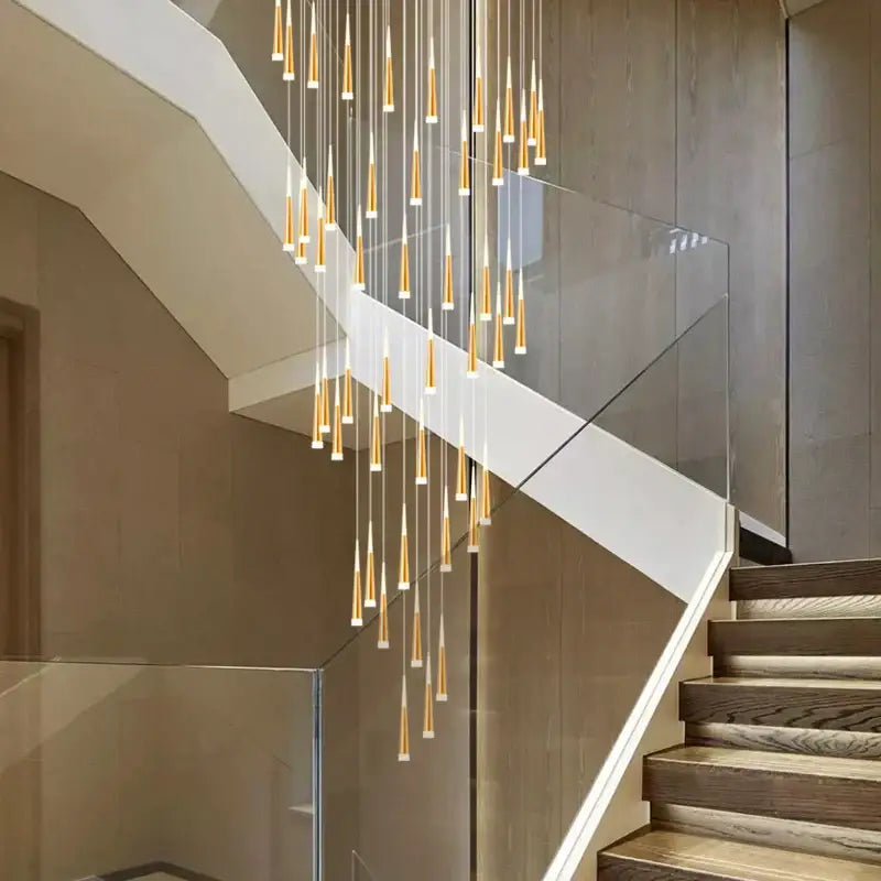 Modern gold-toned decorbites led spiral chandelier with slender cone-shaped lights for black chrome stairwell lighting