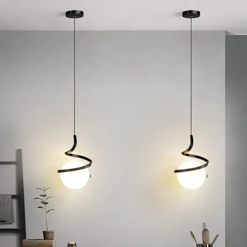 Two sleek black decorbites led spiral pendant lights with frosted glass globe shades for living room lighting