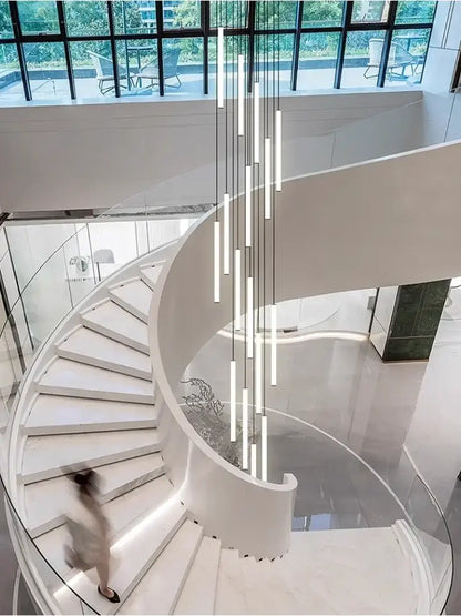 Modern white spiral staircase with glass railings featuring the decorbites™ led spiral staircase chandelier for home decor