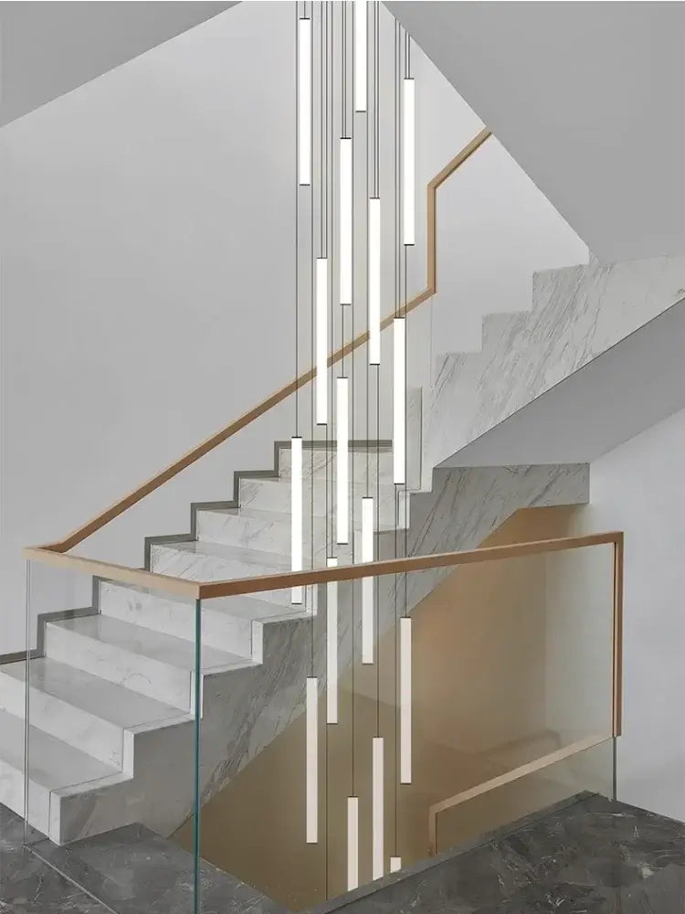 Modern minimalist white marble staircase with glass balustrade and wooden handrail featuring decorbites led spiral staircase chandelier for home decor
