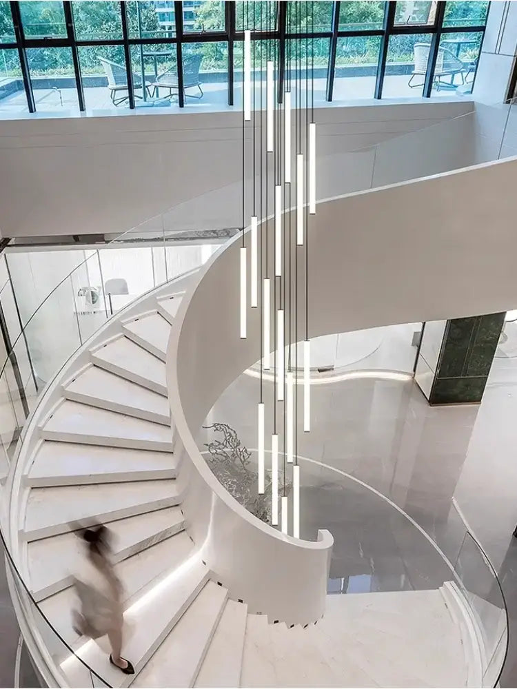 Modern white spiral staircase with glass railings featuring the DecorBites led spiral staircase chandelier for home decoration