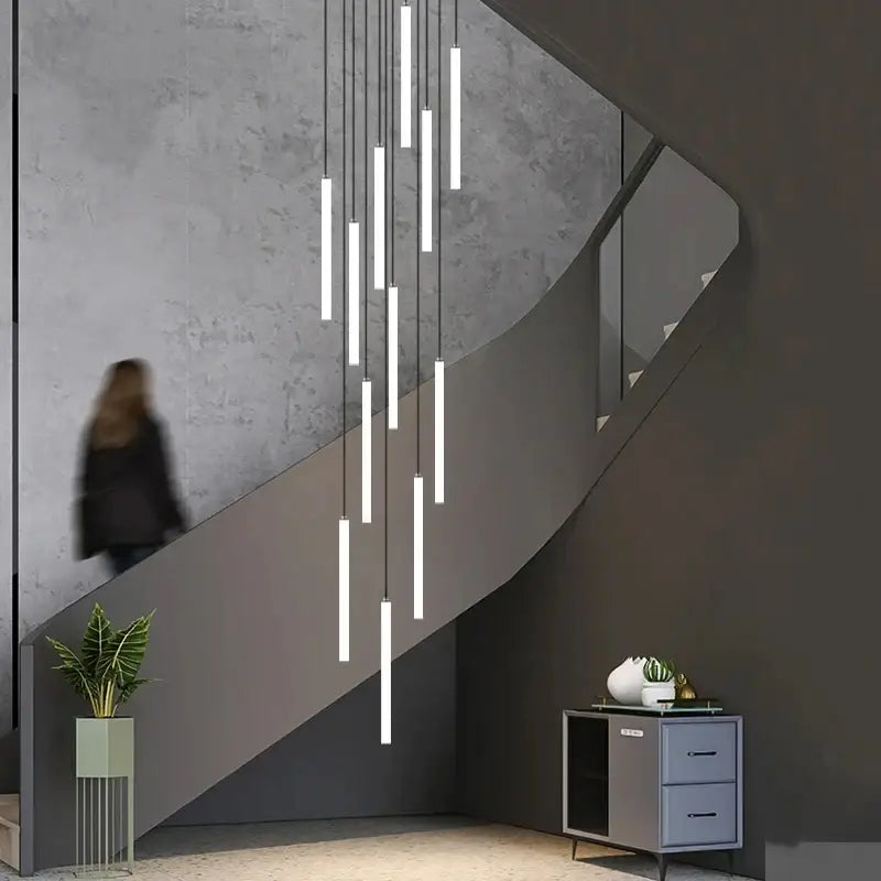 Decorbites™ led spiral staircase chandelier with slender white cylindrical tubes suspended by thin cords for modern homes