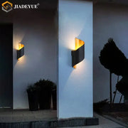 Modern black and gold decorbites led spiral wall sconce with sleek curved design for outdoor and indoor lighting