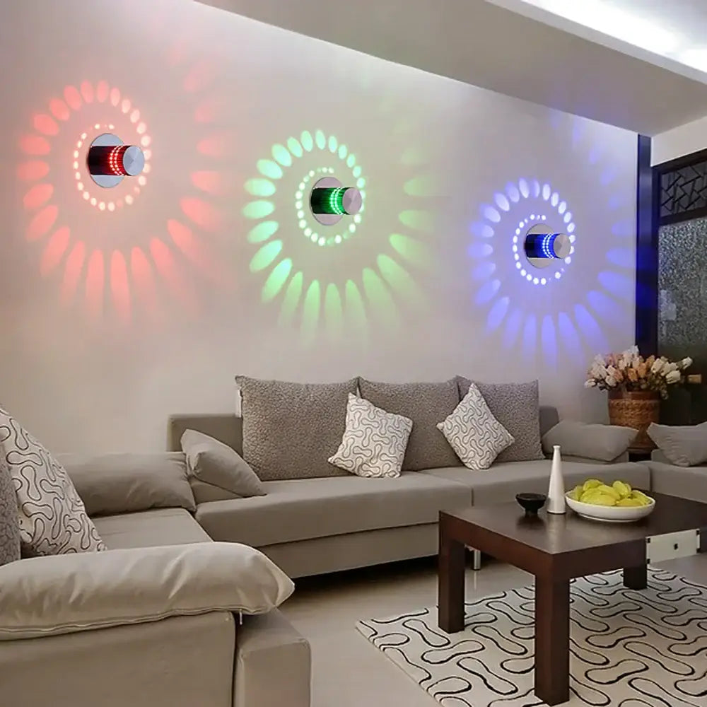 Three decorbites led spiral wall lights casting colorful red green and blue light patterns for home decor use