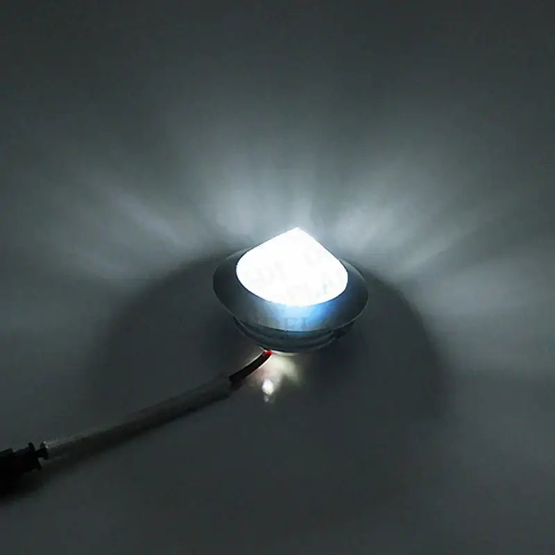 A bright white DecorBites LED spot light mini 3W with sleek metallic housing and attached power cord for cabinets