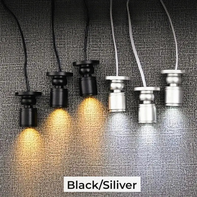 Black and silver decorbites led spotlight with adjustable heads emitting warm and cool white light for cabinets and shelves