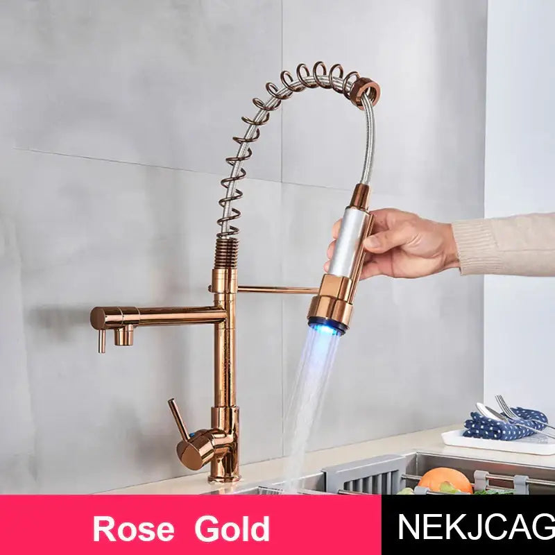 Rose gold decorbites led spring kitchen faucet with flexible coiled hose and pull-out spray head emitting blue light
