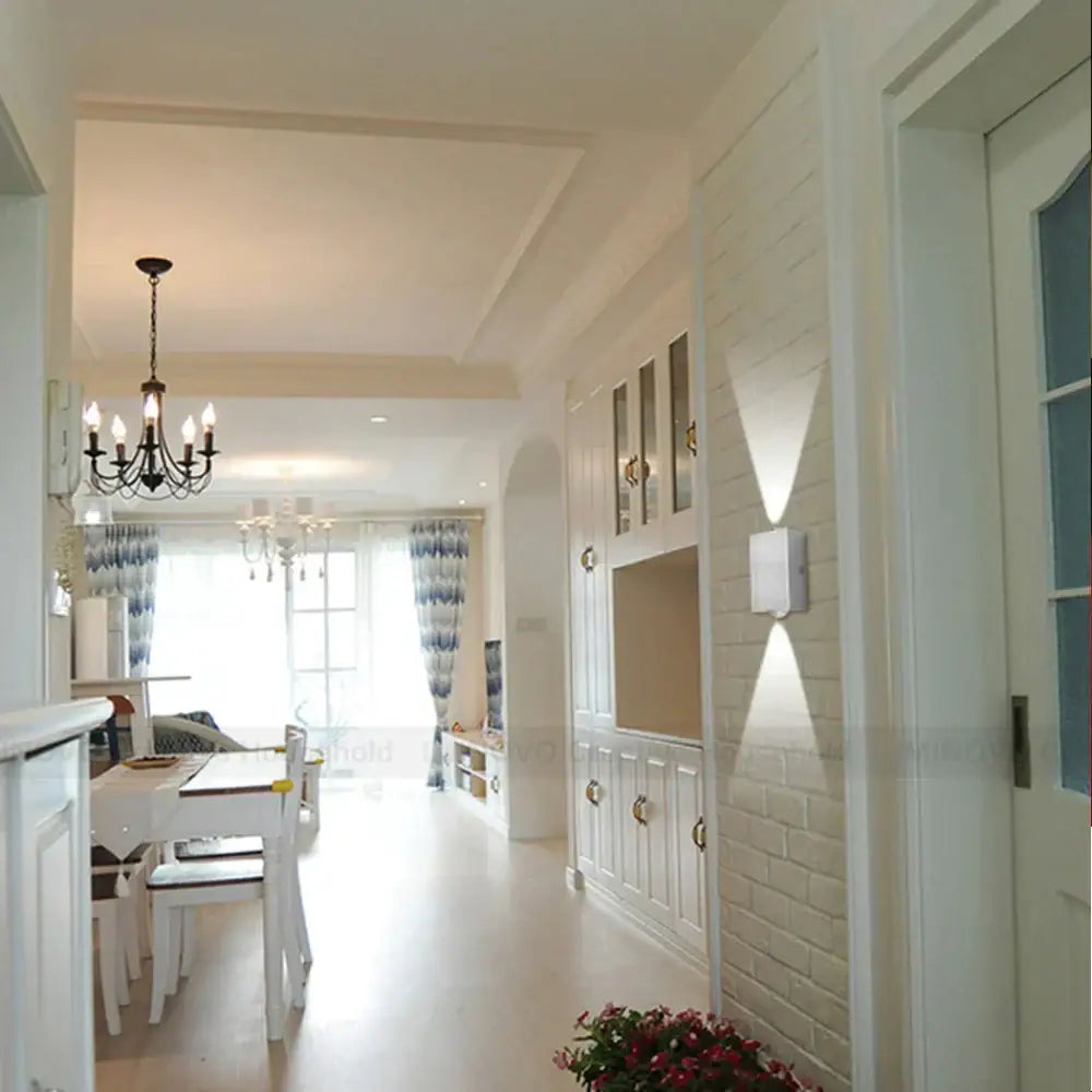 Modern white brick wall with built-in cabinets and gold hardware featuring decorbites led square wall lamp