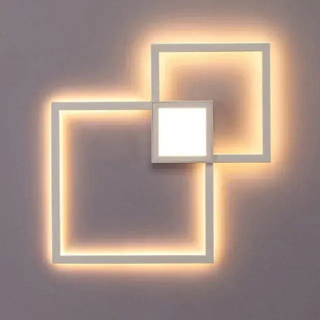 Modern white DecorBites LED square wall lamp with overlapping geometric design and warm ambient lighting for indoor decor