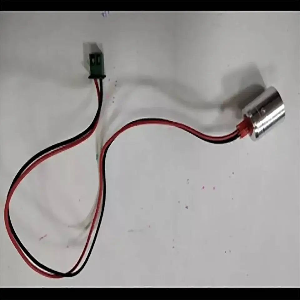Silver cylindrical led stage light with red and black wires connected to green electrical connector for decorbites