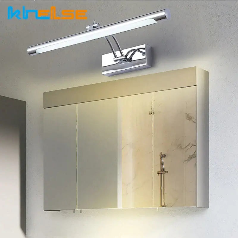 Chrome finished decorbites led stainless steel bathroom wall lamp with adjustable arms mounted above mirrored medicine cabinet