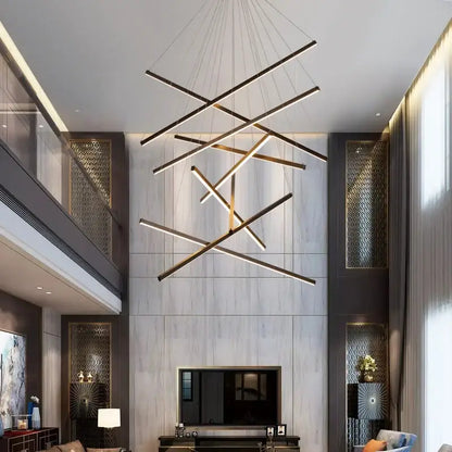 Modern geometric DecorBites™ LED stair ceiling chandelier with black and gold linear bars suspended by thin cables