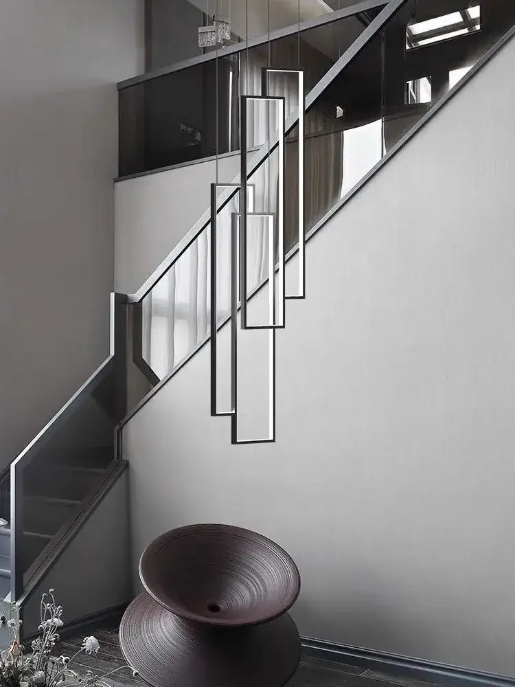 Modern minimalist DecorBites LED stair chandelier with sleek rectangular black metal frames and clear glass for loft lighting