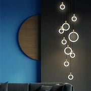 Modern minimalist decorbites led stair chandelier with glowing circular rings and metallic accents for bedroom lighting