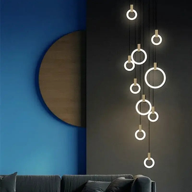 Modern minimalist decorbites led stair chandelier with glowing circular rings and metallic accents for bedroom lighting