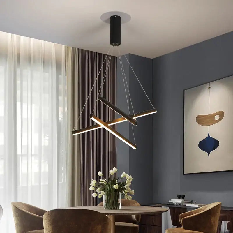Modern black cylindrical decorbites led stair chandelier with intersecting gold-toned bars for indoor lighting